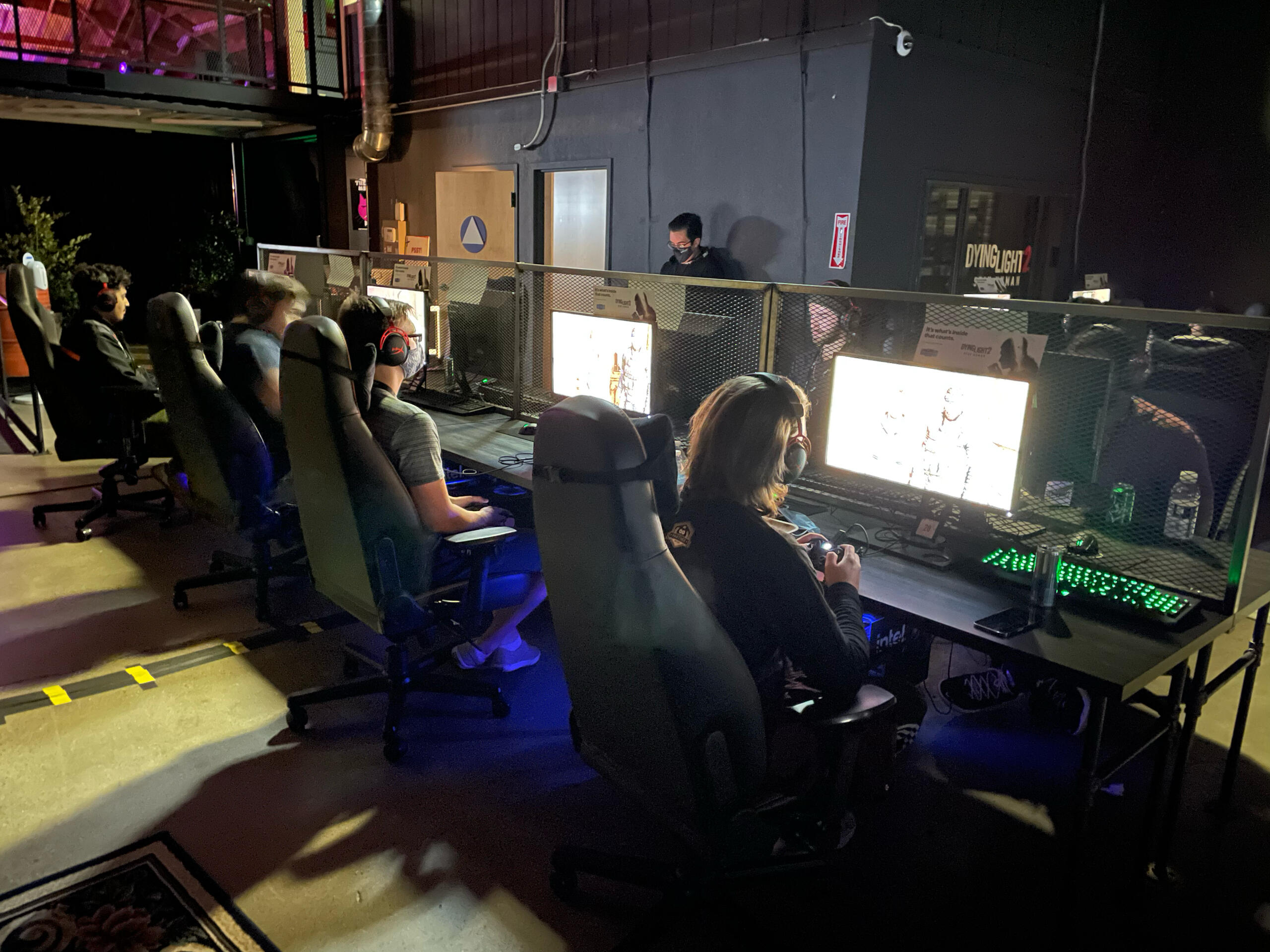 Past Event Image 2 Image of a dozen computers in a dimly lit room. There's players at each computer, previewing a game.